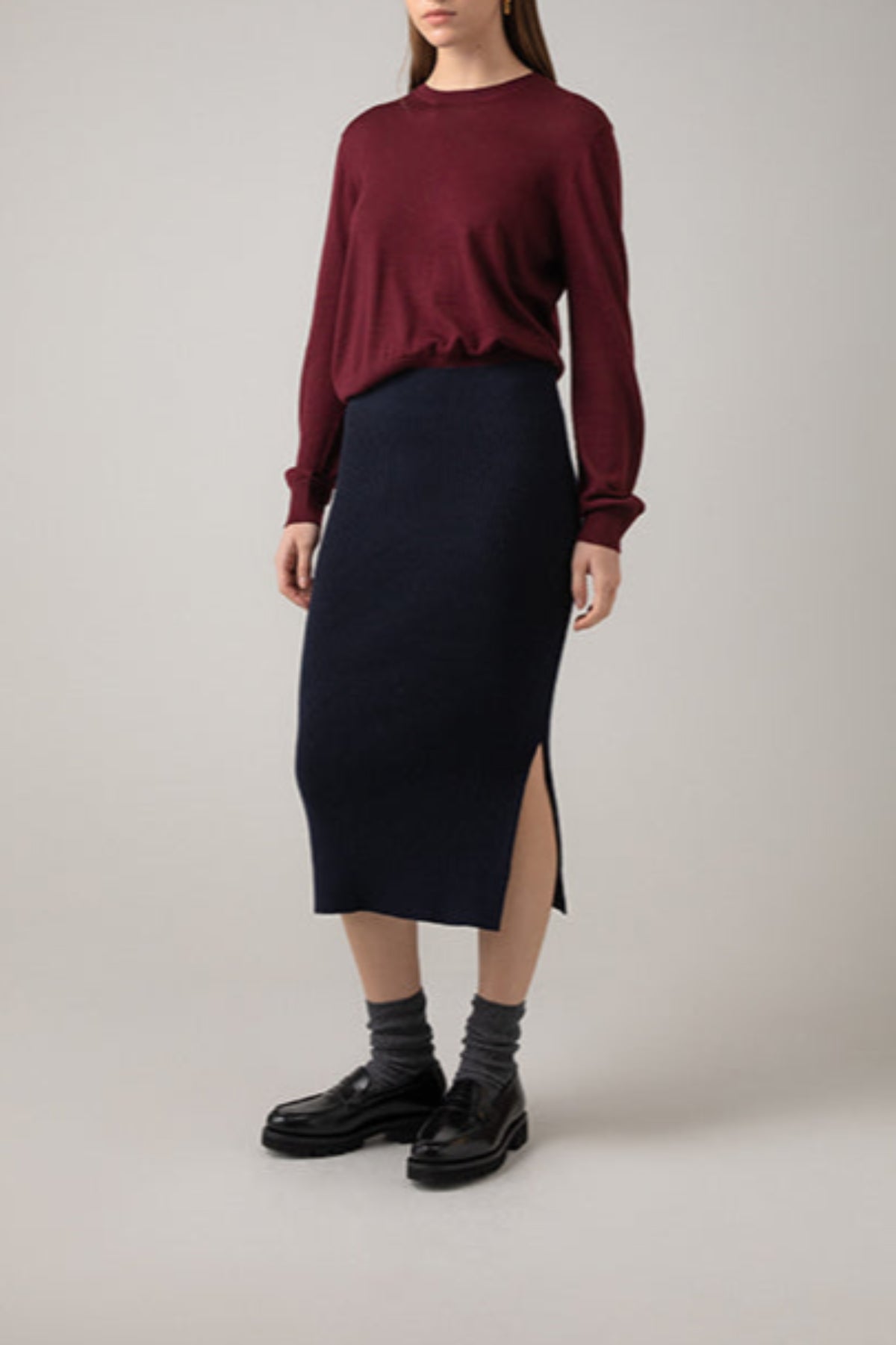 Johnstons of Elgin Ribbed Tube Cashmere Skirt in Dark Navy worn with matching Slim Fit Cashmere Sweater on a grey background KBP00923SD7286