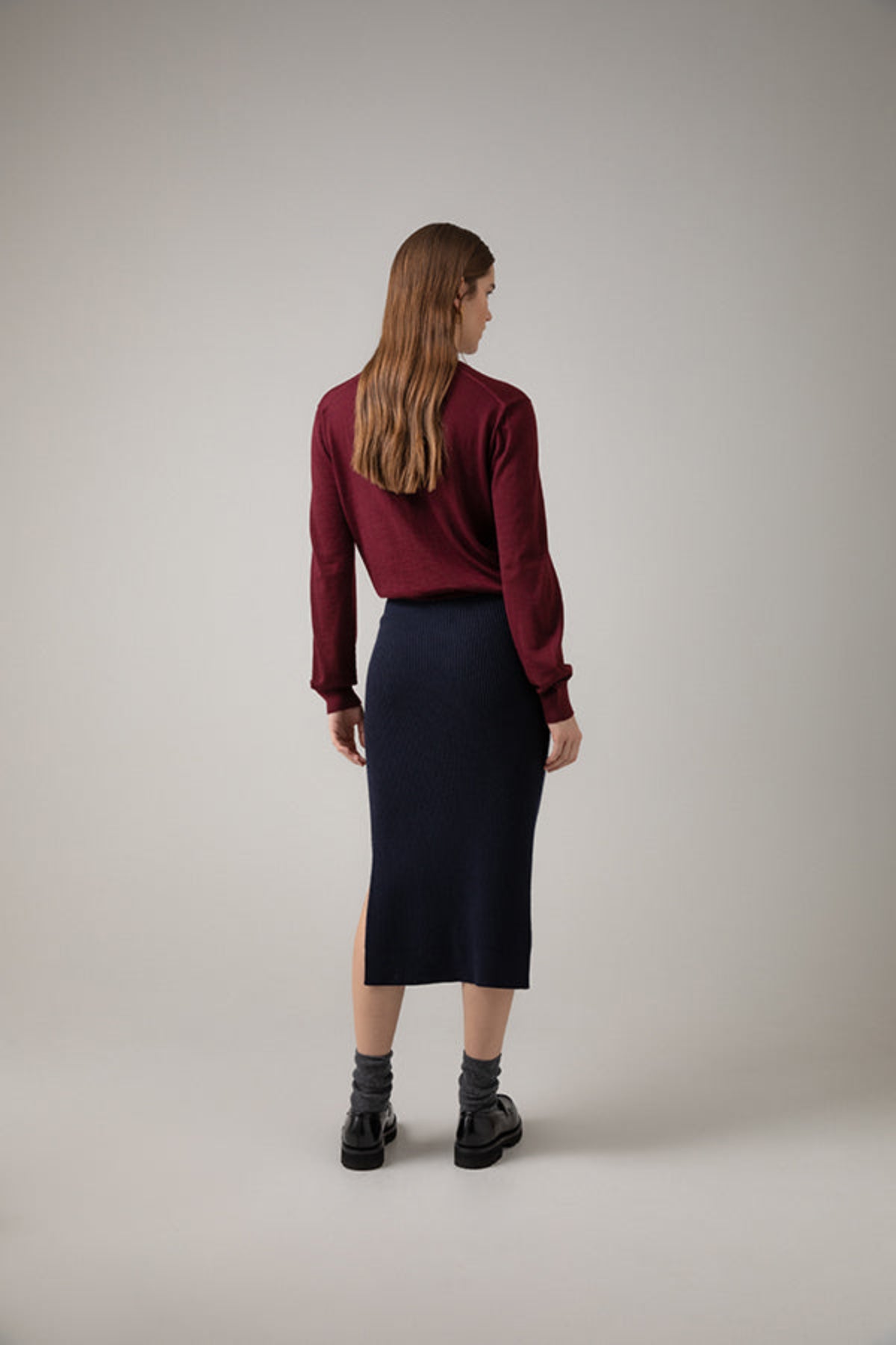 Johnstons of Elgin Ribbed Tube Cashmere Skirt in Dark Navy worn with matching Slim Fit Cashmere Sweater on a grey background KBP00923SD7286