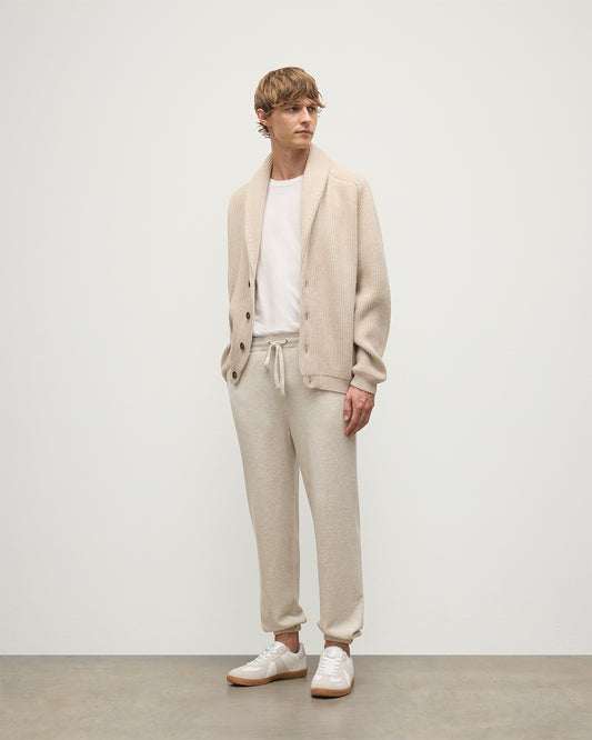 MODEL WEARING JOHNSTONS OF ELGIN MENS KIRK SWEATPANTS NATURAL 97% CASHMERE 3% POLYESTER WITH A WHITE T-SHIRT AND PIONEER CASHMERE CARDIGNA IN NATURAL KBP00948HA0402