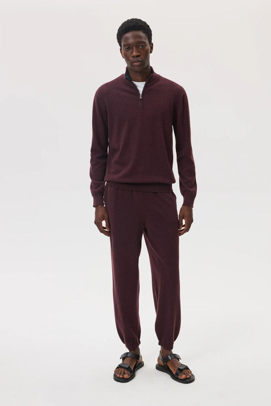 Model wearing Johnstons of Elgin SS25 Men's Knitwear Rosewood Tapered Cashmere Joggers with matching quarter zip cashmere jumper KBP00948SB7089