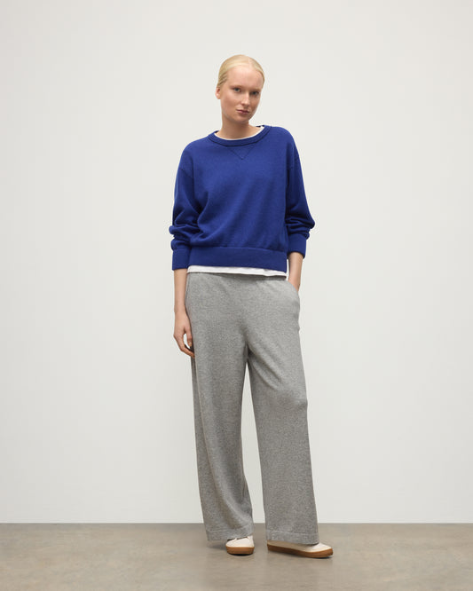 MODEL WEARS JOHNSTONS OF ELGIN WOMENS COLL PANTS LIGHT GREY WITH BLUE CASHMERE SWEATER OVER A WHITE T-SHIRT KBP00996HA0308