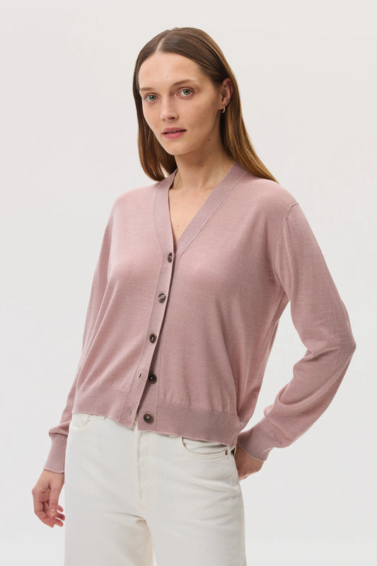 Model wears Johnstons of Elgin SS25 Women's Knitwear Dusty Rose Superfine Merino Wool Cardigan with white jeans KDI00686SE5215