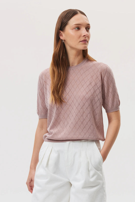 Johnstons of Elgin SS25 Women's Knitwear Dusty Rose Superfine Merino Pointelle Argyle T-Shirt worn with white linen shorts KDI00739SE5215