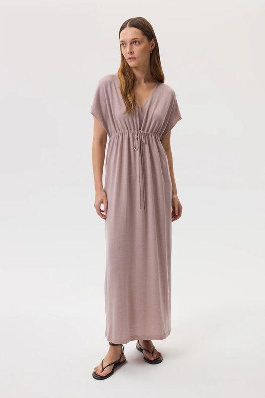 Model wearing Johnstons of Elgin SS25 Women's Knitwear Dusty Rose Superfine Merino Maxi Dress with black sandals on a white backdrop KDI00744SE5215