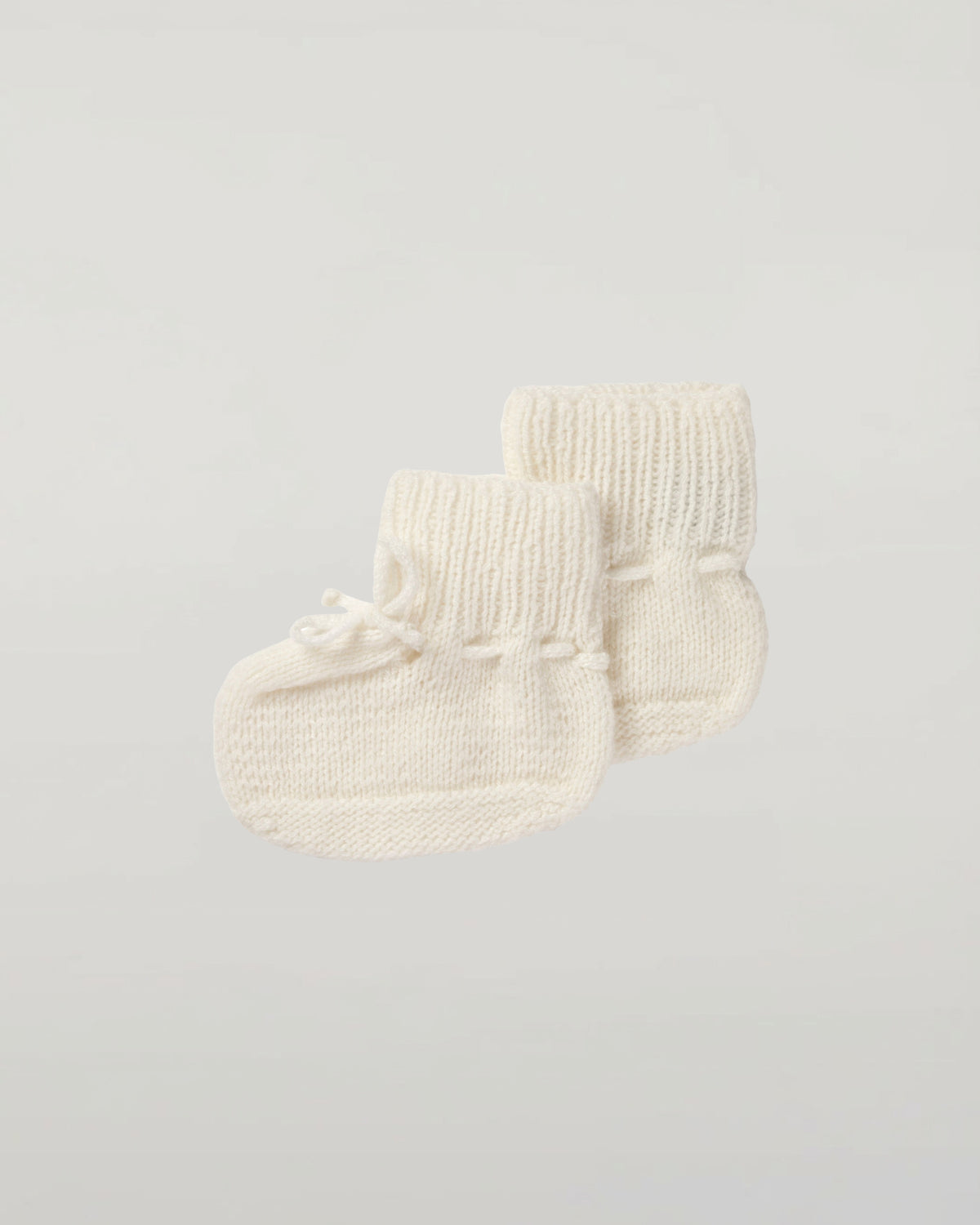 Johnstons of Elgin Hand Knitted Cashmere Baby Booties in Ecru on white background JA000114SA0132ONE