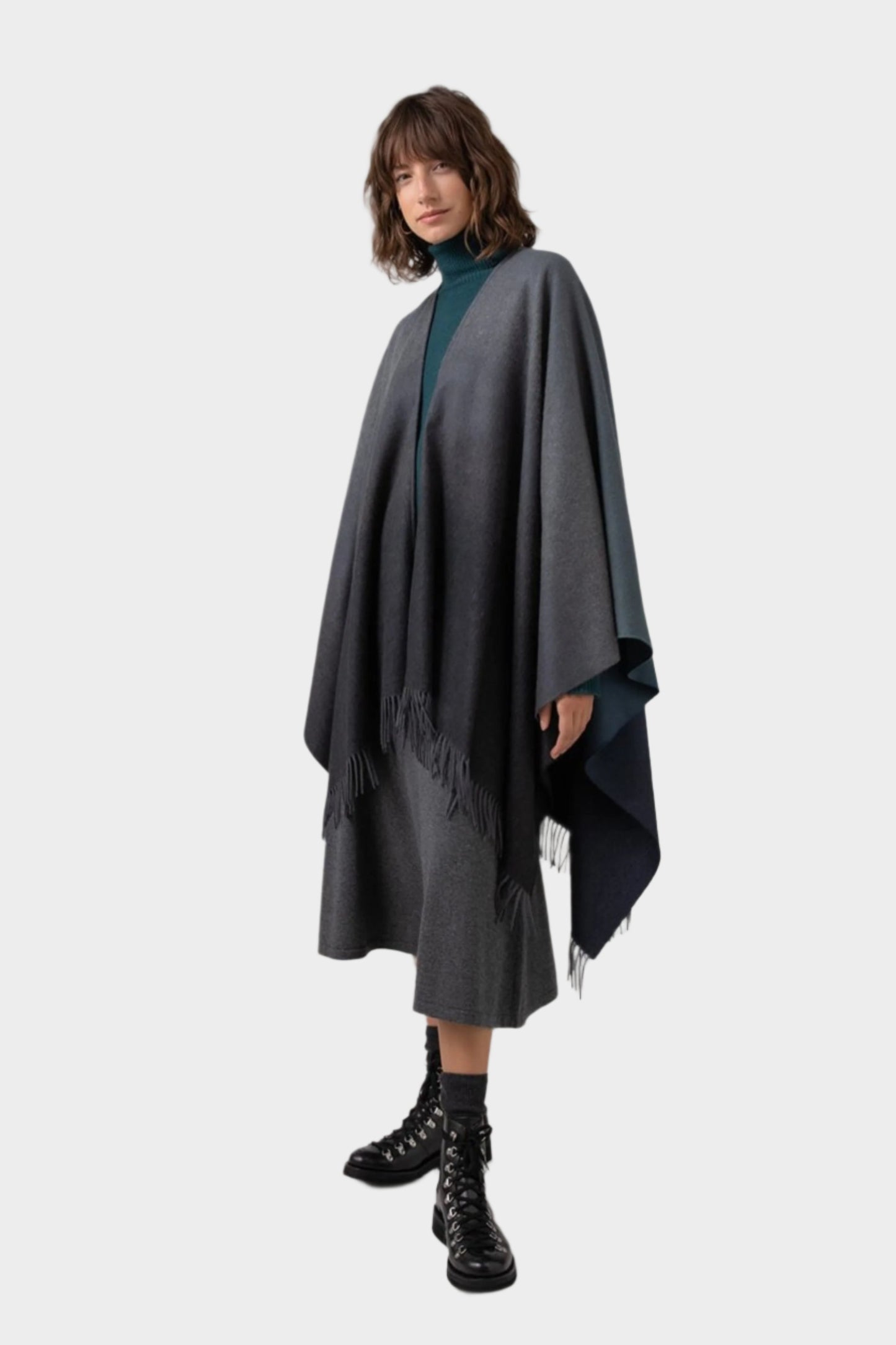 Johnstons of Elgin Ombre Cape in Navy & Back worn by model against a grey background TA000360RU7302ONE