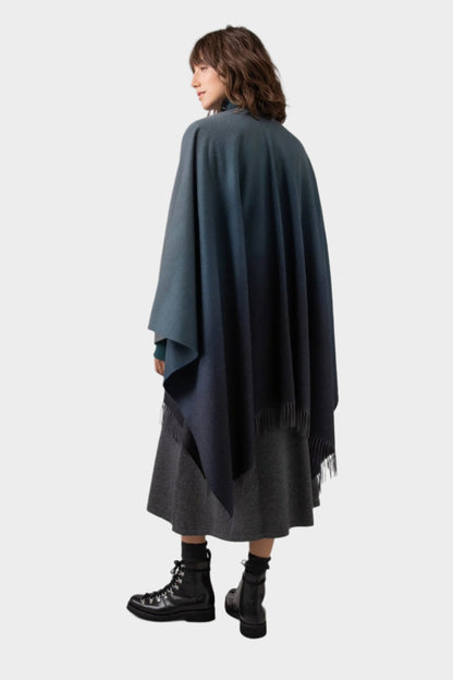 Johnstons of Elgin Ombre Cape in Navy & Back worn by model against a grey background TA000360RU7302ONE