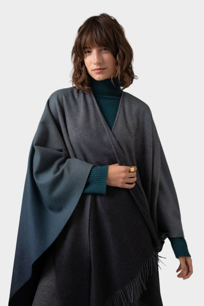 Johnstons of Elgin Ombre Cape in Navy & Back worn by model against a grey background TA000360RU7302ONE