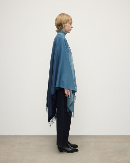 Model wears Johnstons of Elgin AW25 Woven Accessories Seascape & Navy Blue Ombré Cashmere Cape Side View TA000360RU7686ONE