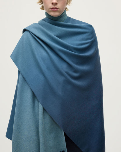Model wears Johnstons of Elgin AW25 Woven Accessories Seascape & Navy Blue Ombré Cashmere Cape Close Up TA000360RU7686ONE