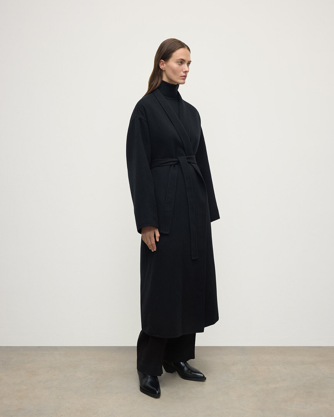 Model wears Johnstons of Elgin AW25 Women's Tailoring Black Black Cashmere Wrap Coat Side View TA000621RU6432