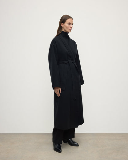 Model wears Johnstons of Elgin AW25 Women's Tailoring Black Black Cashmere Wrap Coat Side View TA000621RU6432