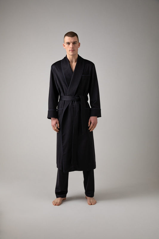Johnstons of Elgin’s Men's Navy Cashmere Dressing Gown with Silk Lining on model wearing navy bottoms on a grey background TA000472RU65880