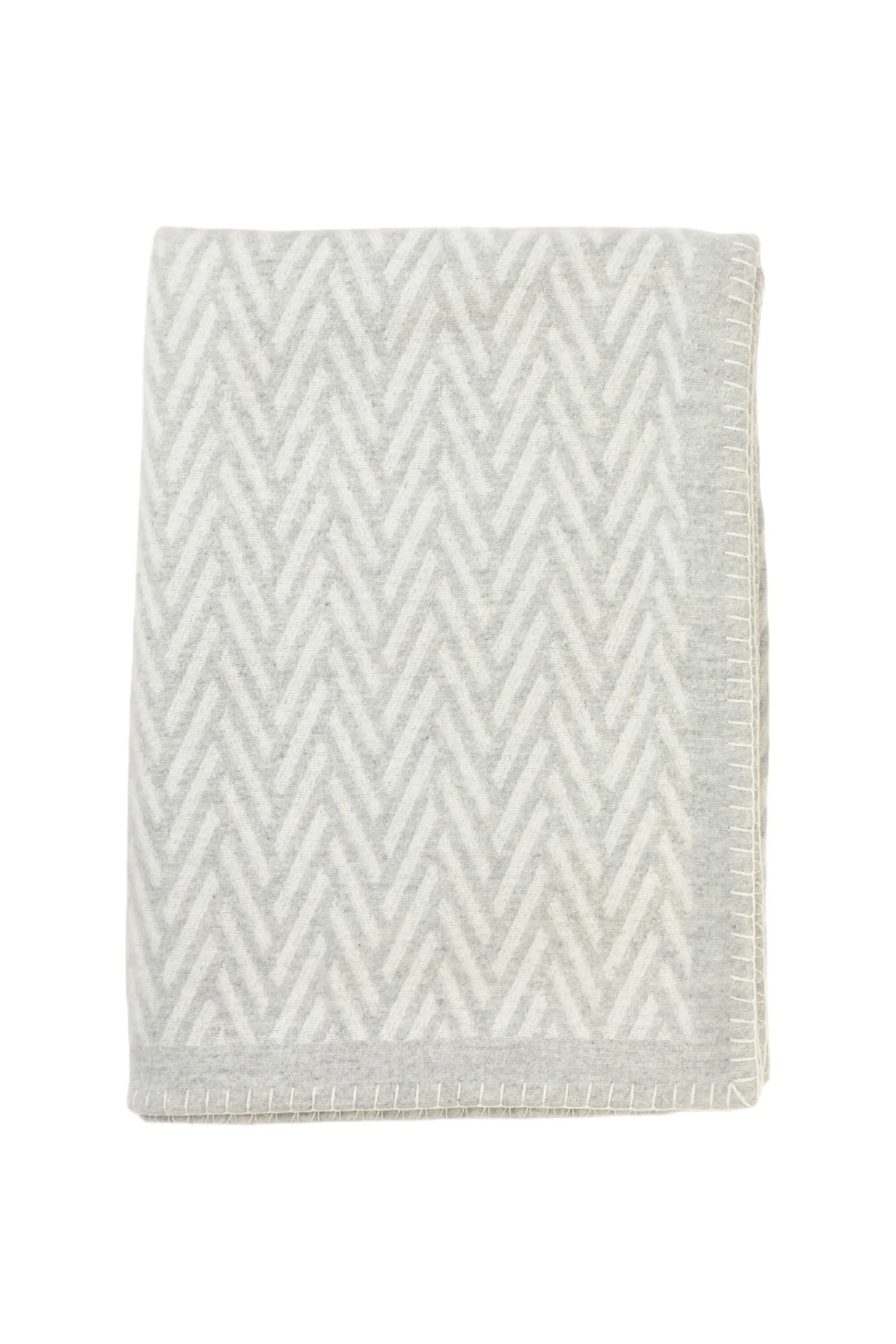 Johnstons of Elgin Merino Cashmere Blend Chevron Throw in Silver & White folded on a white background TB000500RU6972ONE