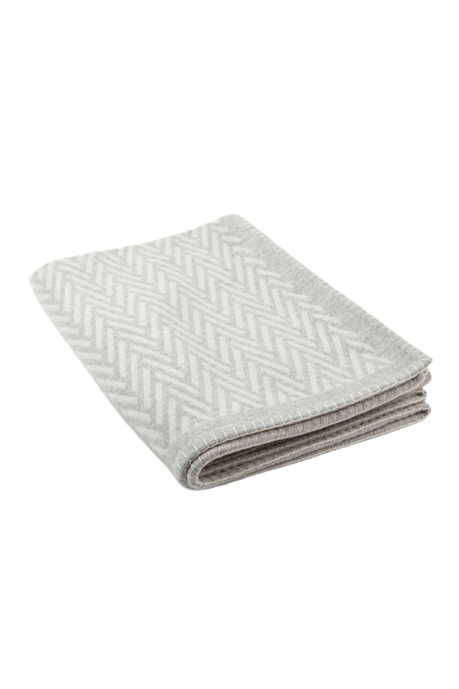 Johnstons of Elgin Merino Cashmere Blend Chevron Throw in Silver & White folded on a white background TB000500RU6972ONE