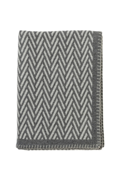 Johnstons of Elgin’s Grey Herringbone Blanket Stitch Throw on a white background TB000500RU6973ONE