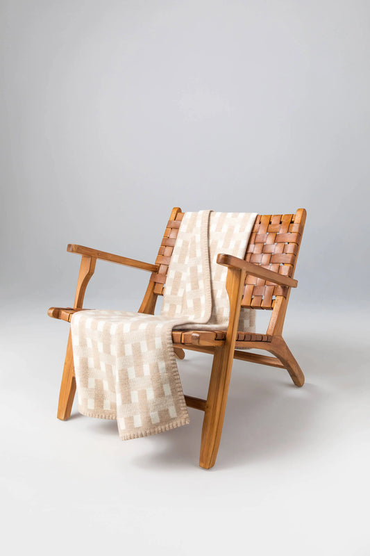 2025 Johnstons of Elgin Interiors Collection Oatmeal & White Blanket Stitched Basketweave Throw on a wooden chair  TB000500RU7443ONE