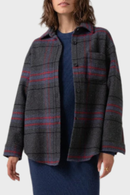 Johnstons of Elgin Women's Wool Blend Oversized Shirt in Charcoal Check worn with a Navy Cashmere Sweater & Skirt on a grey background TB000630RU7387