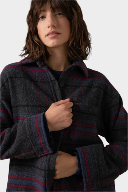 Johnstons of Elgin Women's Wool Blend Oversized Shirt in Charcoal Check worn with a Navy Cashmere Sweater on a grey background TB000630RU7387