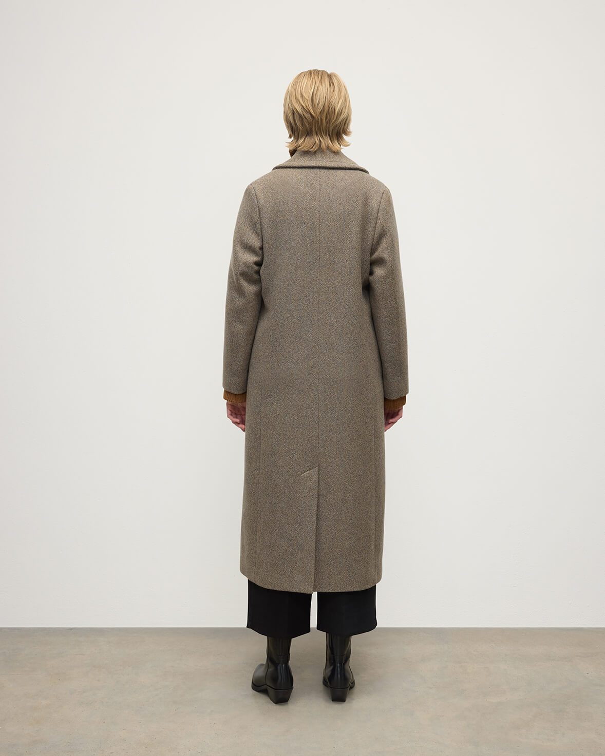 Model wears Johnstons of Elgin AW25 Women's Tailoring Partridge Tweed Herringbone The Great Coat in Brown Back View TD000438RU7671