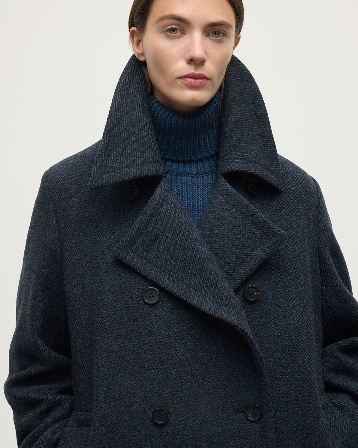 Model wearing Johnstons of Elgin  Women's Tailoring Bottle Dark Twill The Great Coat in Green Front View TD000438RU7672