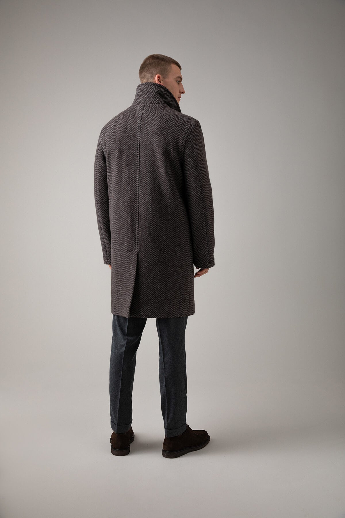 Johnstons of Elgin’s Men's Charcoal Herringbone Wool Car Coat on model wearing grey trousers on a grey background TD000620RU7395