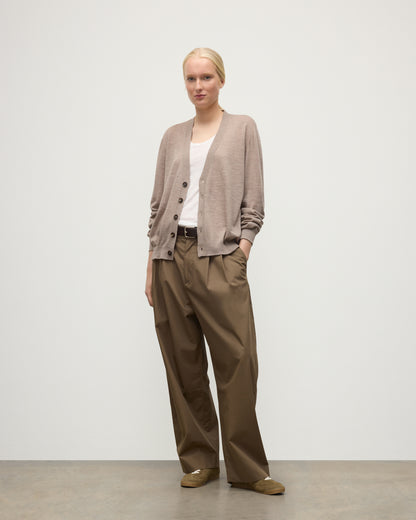 FEMALE MODEL WEARING JOHNSTONS OF ELGIN FORSYTH SUPERFINE VEE NECK CARDIGAN LIGHT BROWN WITH BROWN WIDE LEG TROUSERS UAI05740HB0273