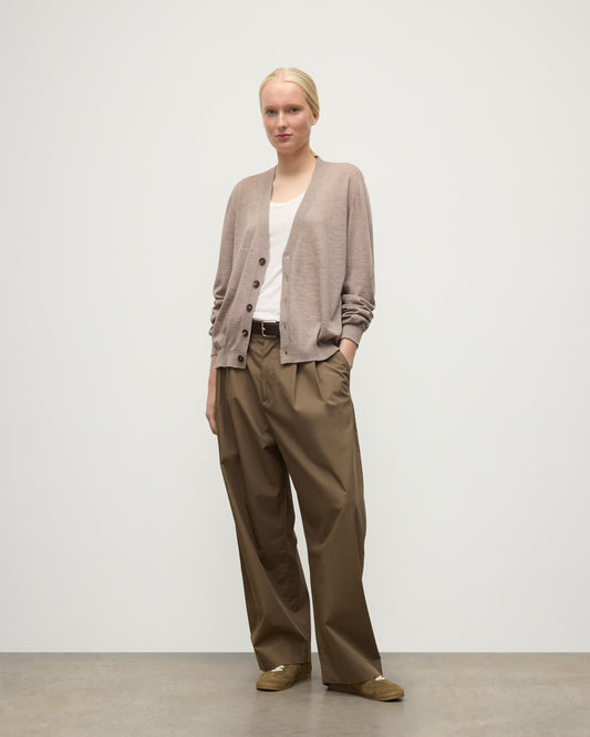 FEMALE MODEL WEARING JOHNSTONS OF ELGIN FORSYTH SUPERFINE VEE NECK CARDIGAN LIGHT BROWN WITH BROWN WIDE LEG TROUSERS UAI05740HB0273
