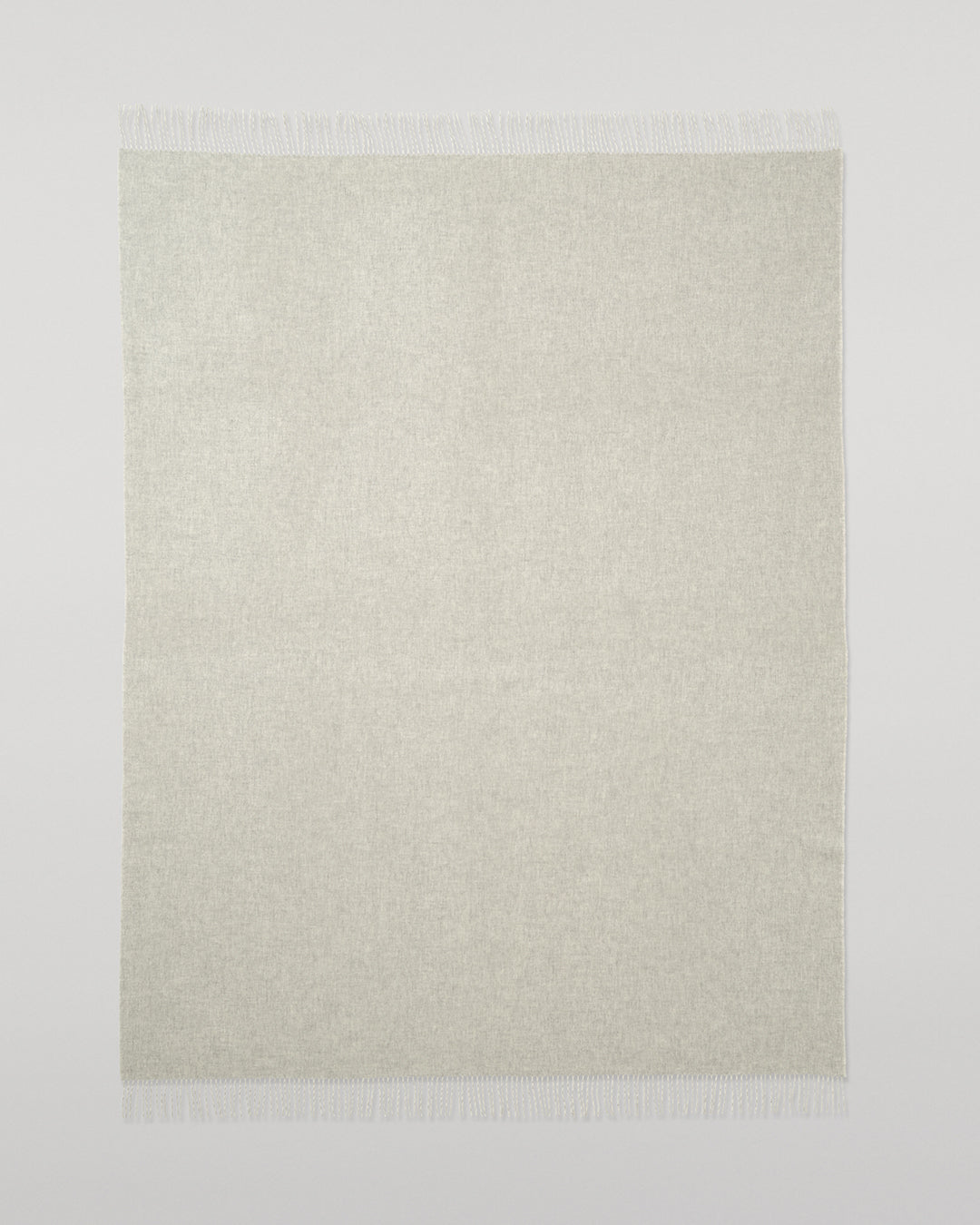 Johnstons of Elgin Interiors Collection Reversible Silver & White Cashmere Throw on a wooden chair WA000013RU5059ONE