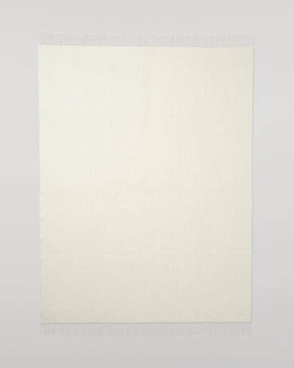 Johnstons of Elgin Interiors Collection Reversible Silver & White Cashmere Throw on a wooden chair WA000013RU5059ONE