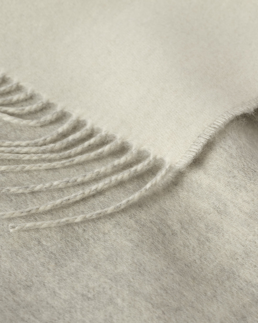 Johnstons of Elgin Interiors Collection Reversible Silver & White Cashmere Throw on a wooden chair WA000013RU5059ONE