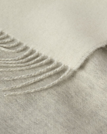 Johnstons of Elgin Interiors Collection Reversible Silver & White Cashmere Throw on a wooden chair WA000013RU5059ONE