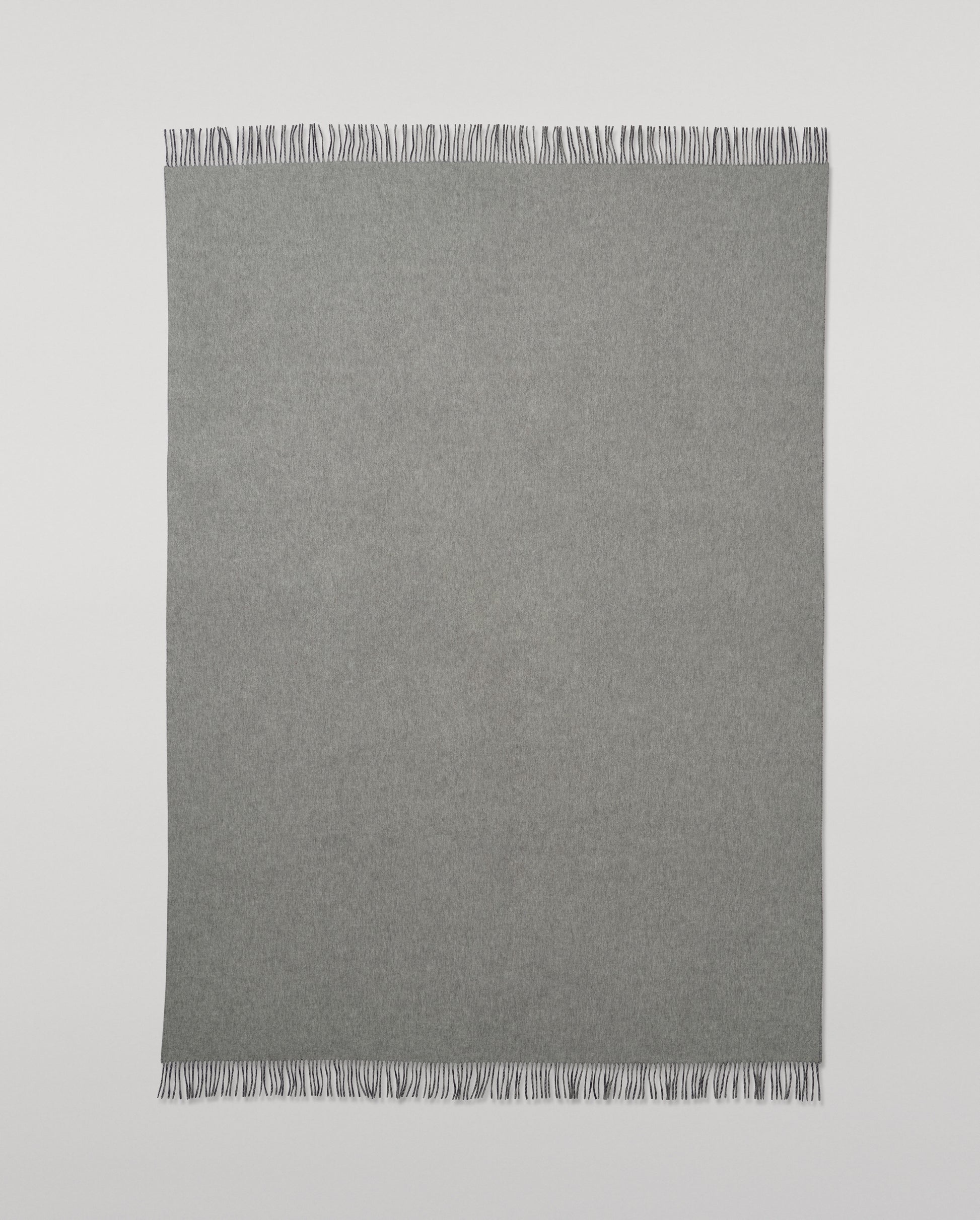 Johnstons of Elgin Interiors Collection  Reversible Navy & Light Grey Cashmere Throw on a wooden chair  WA000013RU6632N/A