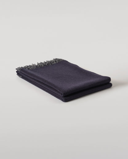 Johnstons of Elgin Interiors Collection  Reversible Navy & Light Grey Cashmere Throw on a wooden chair  WA000013RU6632N/A