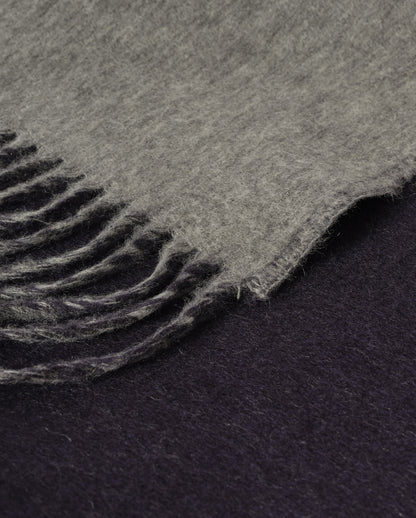 Johnstons of Elgin Interiors Collection  Reversible Navy & Light Grey Cashmere Throw on a wooden chair  WA000013RU6632N/A