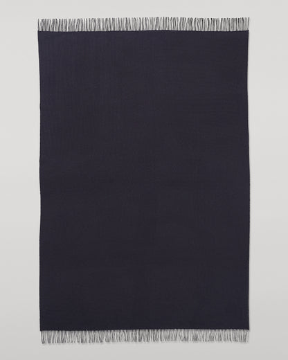 Johnstons of Elgin Interiors Collection  Reversible Navy & Light Grey Cashmere Throw on a wooden chair  WA000013RU6632N/A