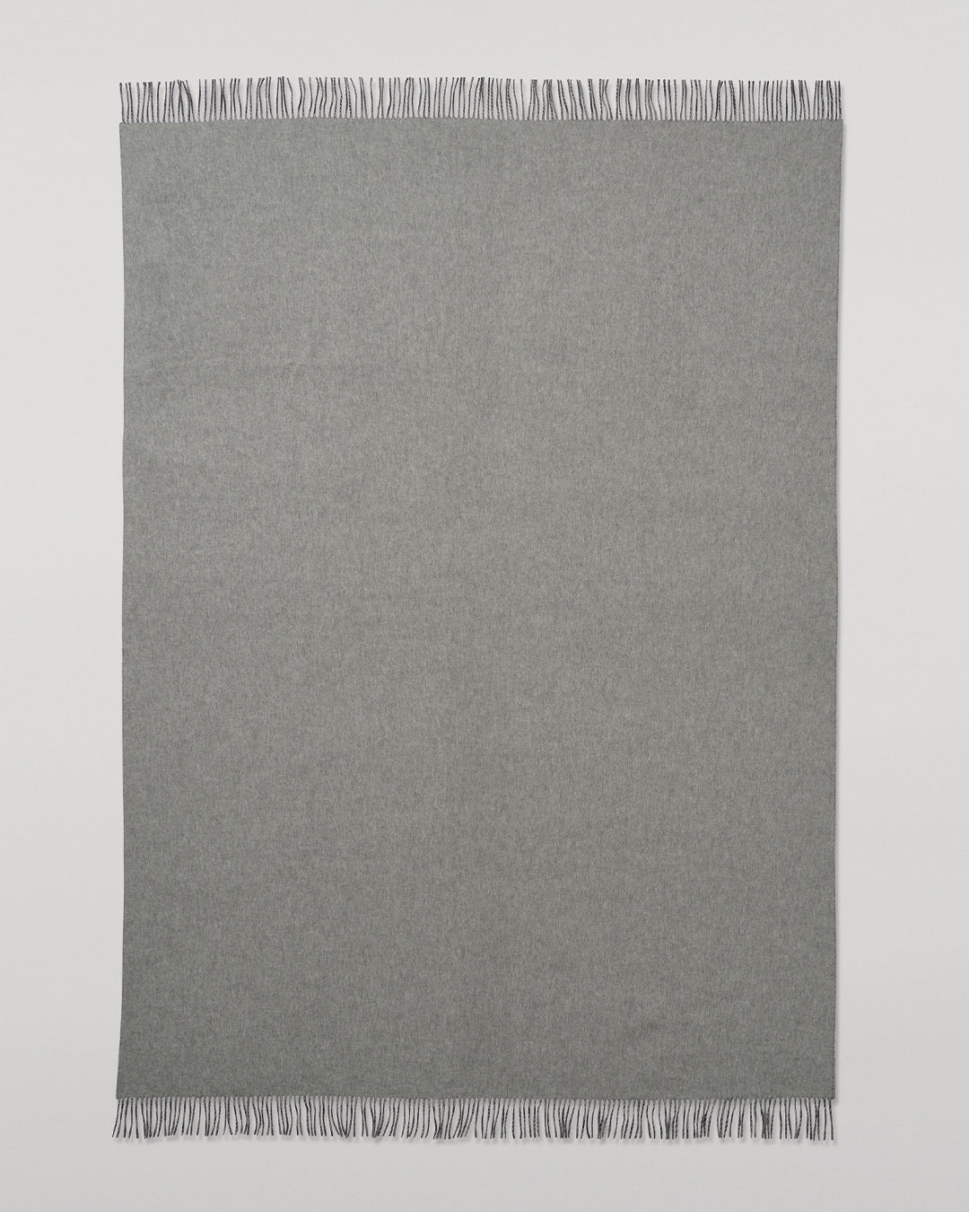 Johnstons of Elgin Interiors Collection  Reversible Navy & Light Grey Cashmere Throw on a wooden chair  WA000013RU6632N/A