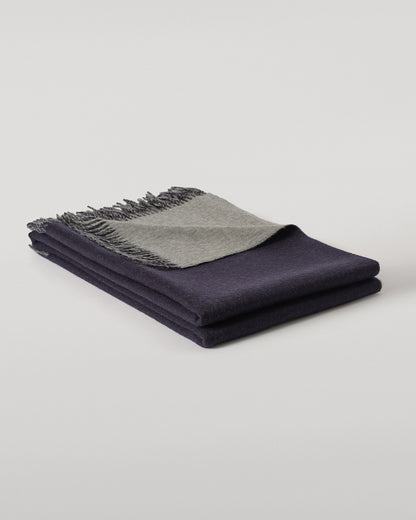 Johnstons of Elgin Interiors Collection  Reversible Navy & Light Grey Cashmere Throw on a wooden chair  WA000013RU6632N/A