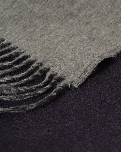 Johnstons of Elgin Interiors Collection  Reversible Navy & Light Grey Cashmere Throw on a wooden chair  WA000013RU6632N/A