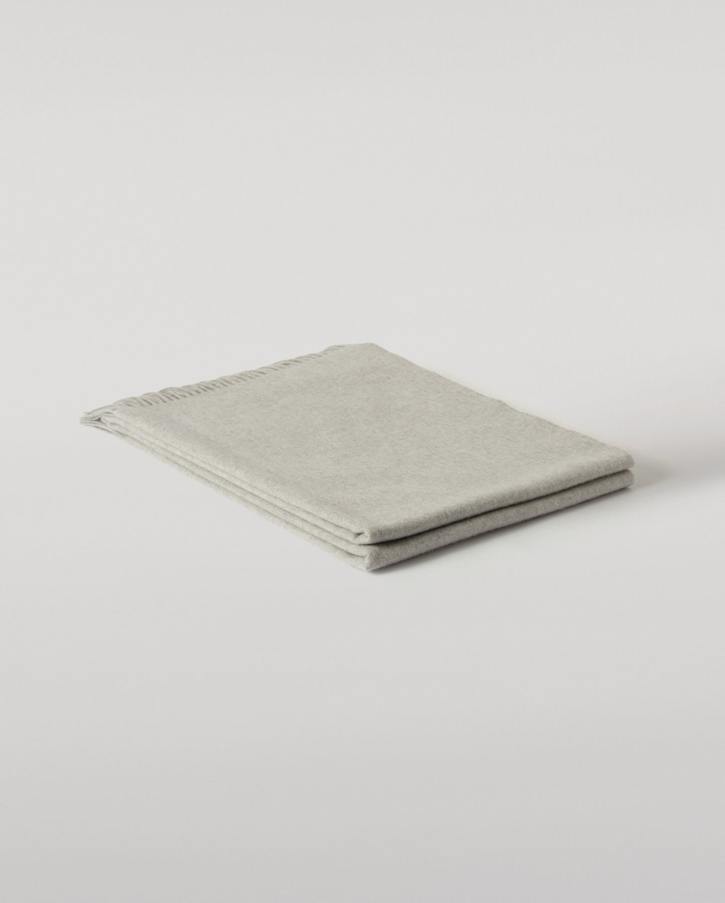 Johnstons of Elgin Interiors Collection  Silver Cashmere Throw on a wooden chair background  WA000055HA0100ONE