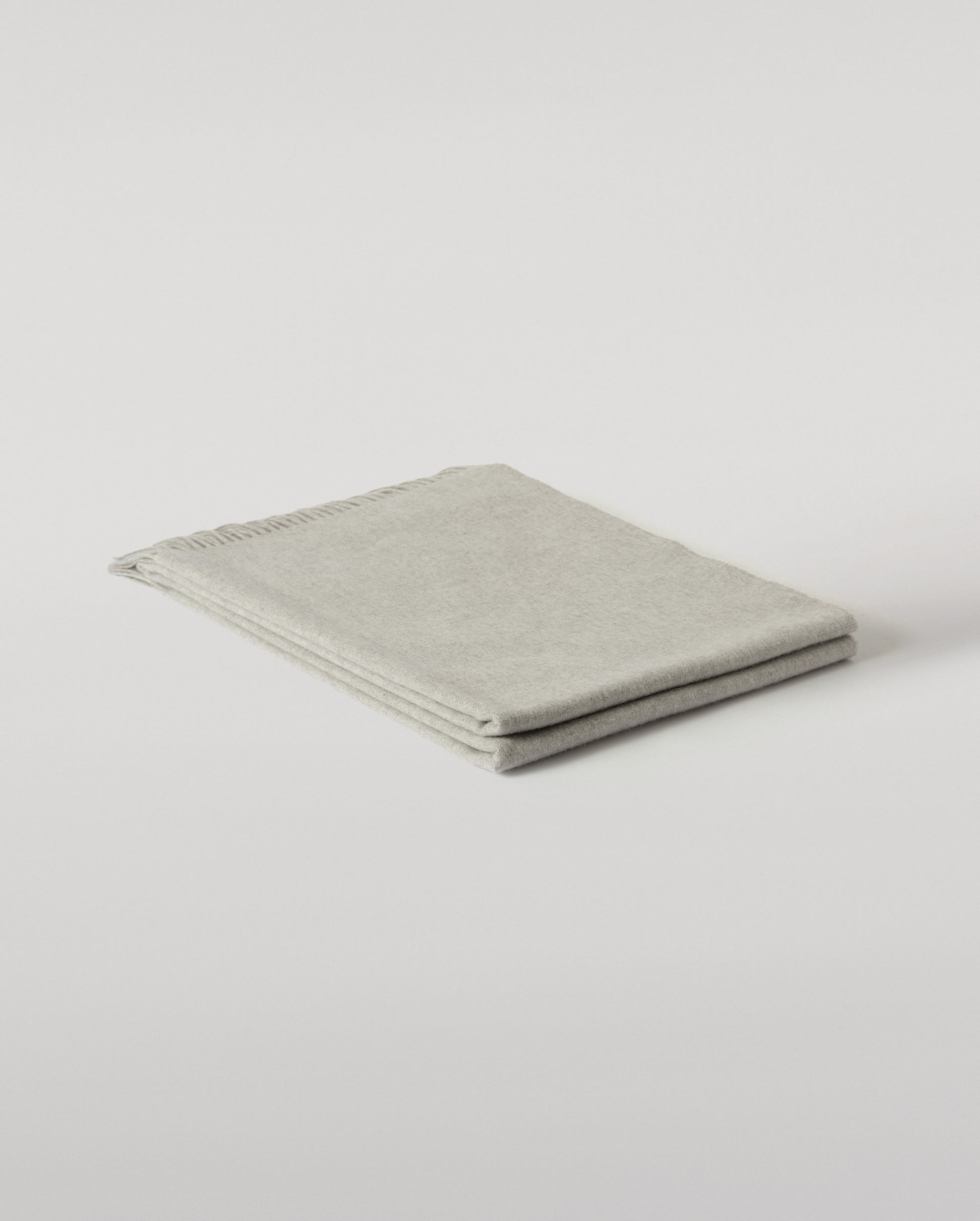 Johnstons of Elgin Interiors Collection  Silver Cashmere Throw on a wooden chair background  WA000055HA0100ONE