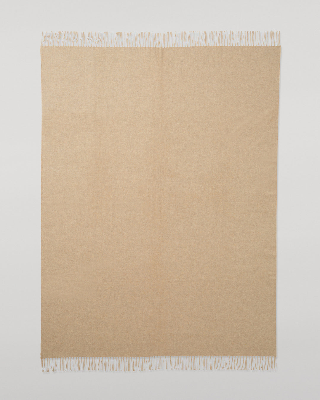 Johnstons of Elgin Interiors Collection Oatmeal Cashmere Throw on a wooden chair WA000055HB0210ONE