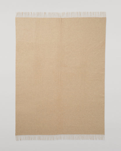 Johnstons of Elgin Interiors Collection Oatmeal Cashmere Throw on a wooden chair WA000055HB0210ONE