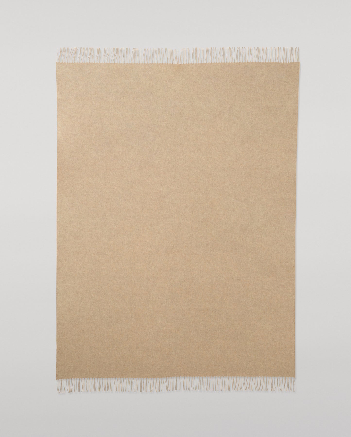 Johnstons of Elgin Interiors Collection Oatmeal Cashmere Throw on a wooden chair WA000055HB0210ONE