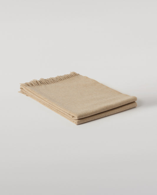 Johnstons of Elgin Interiors Collection Oatmeal Cashmere Throw on a wooden chair WA000055HB0210ONE