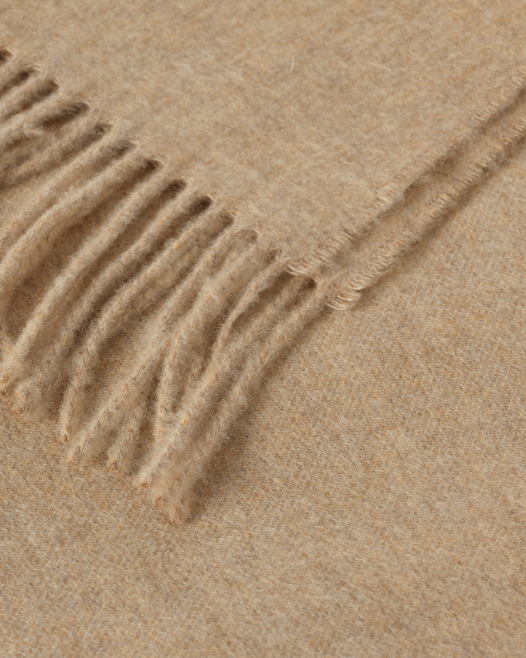 Johnstons of Elgin Interiors Collection Oatmeal Cashmere Throw on a wooden chair WA000055HB0210ONE