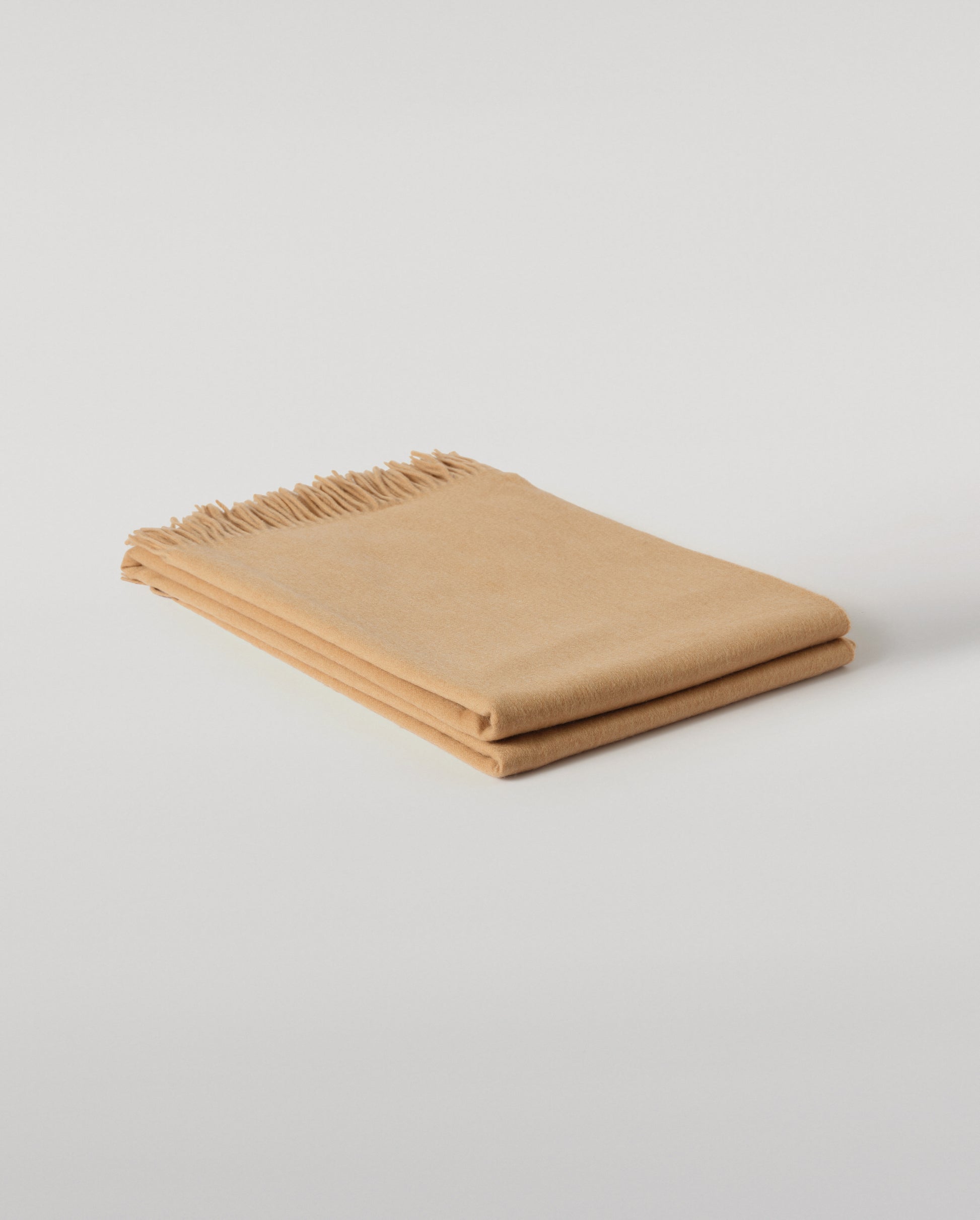 Johnstons of Elgin Interiors Collection Camel Camel Cashmere Throw on a wooden chair WA000055HB4315ONE