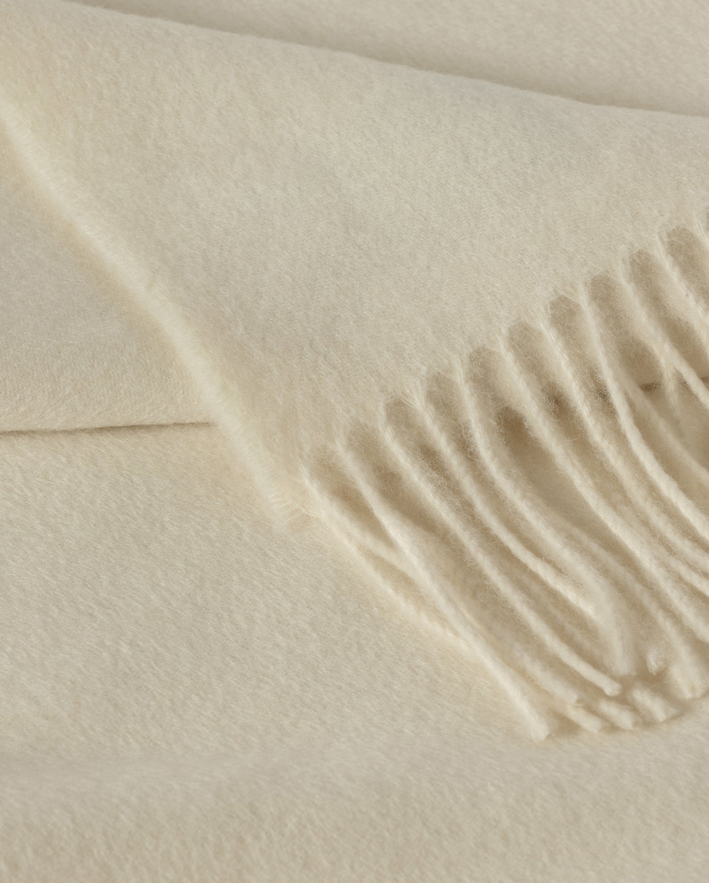 Johnstons of Elgin Interiors Collection White Cashmere Throw on grey background WA000055SA0000ONE