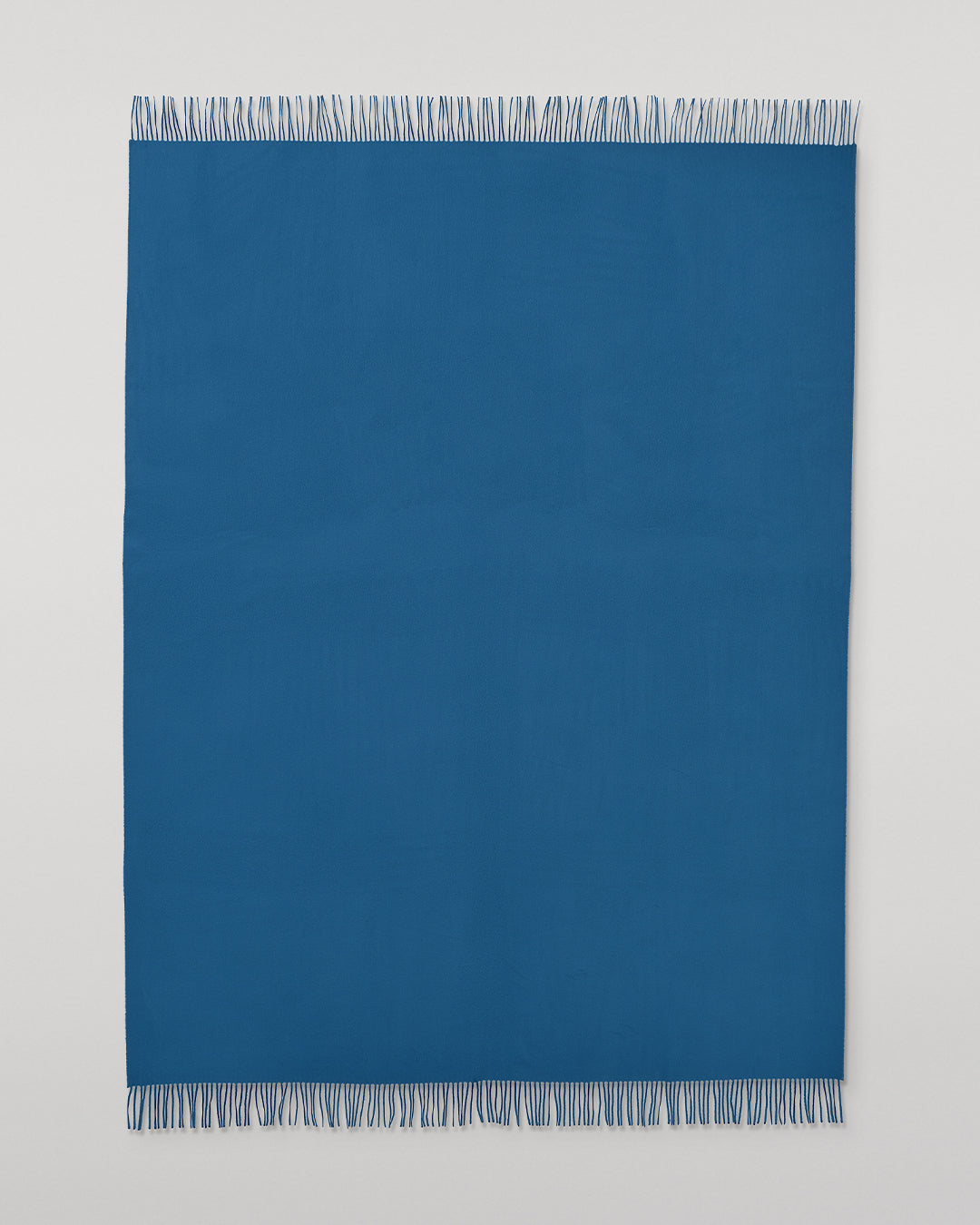 Johnstons of Elgin Plain Cashmere Throw in Petrol – luxury Scottish-woven cashmere throw in a rich petrol blue shade. WA000055SD5123ONE
