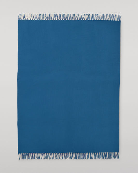 Johnstons of Elgin Plain Cashmere Throw in Petrol – luxury Scottish-woven cashmere throw in a rich petrol blue shade. WA000055SD5123ONE
